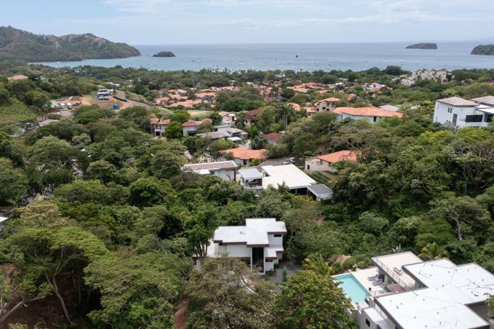 Aerial view over the treetops to the bay at Playas del Coco, with Casa Joanna in the foreground