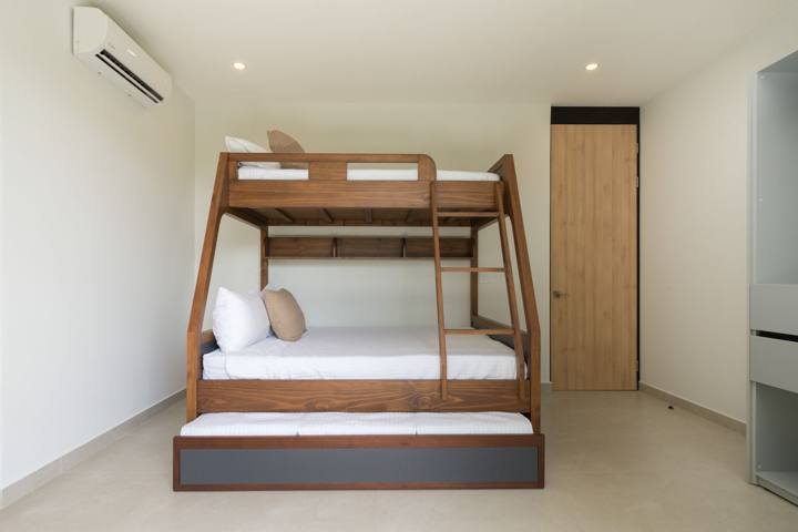 Family suite with a wooden queen-over-twin bunk bed and pull-out trundle